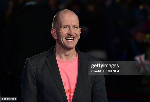 British former Olympic ski jumper Eddie "the eagle" Edwards poses for a photograph as he arrives for the European premiere of Eddie The Eagle in...