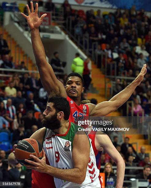 Laboral Kutxa's Ioannis Bourousis vies with CSKA Moscow's Kyly Hinnes during the Euroleague group F Top 16 round 11 basketball match CSKA Moscow vs...