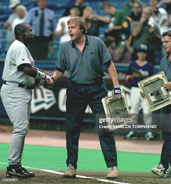 San Diego Padres' Tony Gwynn is congratulated by grounds crew members as they exchange first bases after he hit his 3000th career hit, a single,...