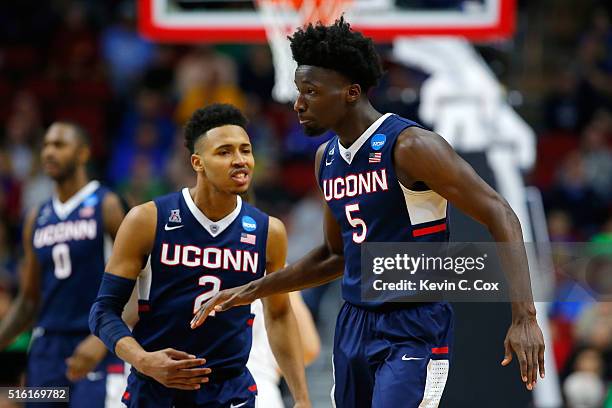 Daniel Hamilton of the Connecticut Huskies reacts with Jalen Adams after a dunk in the second half against the Colorado Buffaloes during the first...