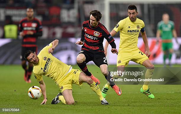 Antonio Rukavina of Villarreal challenges Robbie Kruse of Bayer Leverkusen during the UEFA Europa League round of 16, second leg match between Bayer...