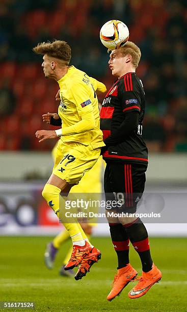 Julian Brandt of Bayer Leverkusen oujtumps Samu Castillejo of Villarreal during the UEFA Europa League round of 16, second leg match between Bayer...