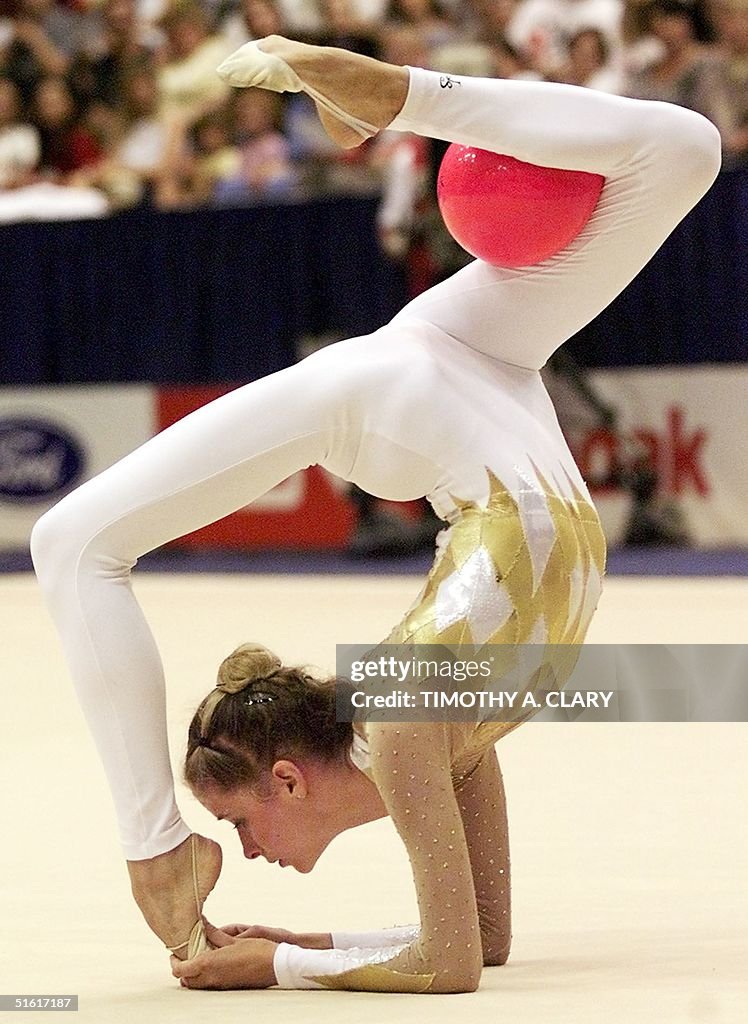 Emilie Livingston of Canada performs with the ball