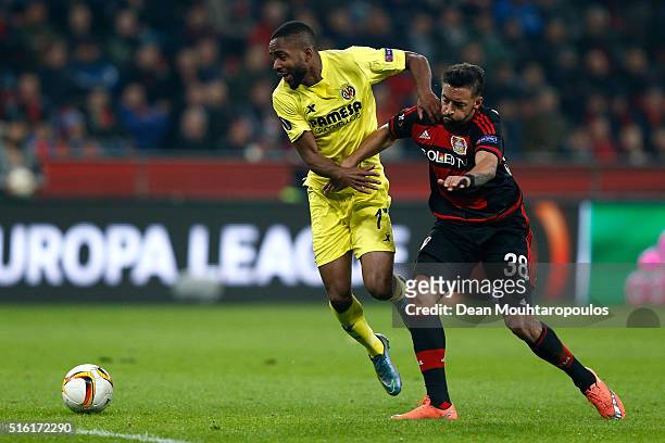 Cedric Bakambu of Villarreal and Karim Bellarabi of Bayer Leverkusen battle for the ball during the UEFA Europa League round of 16, second leg match...