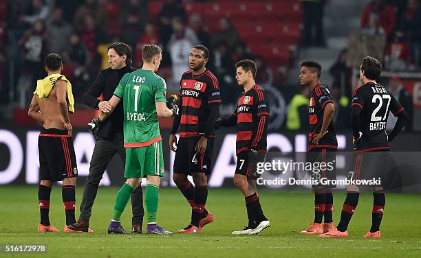 Roger Schmidt head coach of Bayer Leverkusen consoles dejected Bayer Leverkusen players as they lose 2-0 on aggregate after the UEFA Europa League...