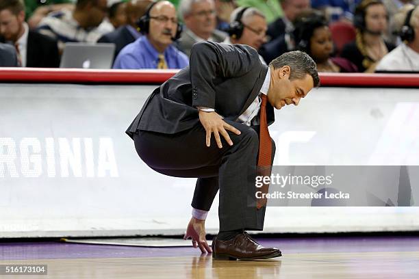 Head coach Tony Bennett of the Virginia Cavaliers falls to the court in the first half while taking on the Hampton Pirates in the first round of the...