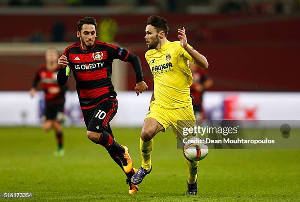 Alfonso Pedraza of Villarreal and Hakan Calhanoglu of Bayer Leverkusen battle for the ball during the UEFA Europa League round of 16, second leg...