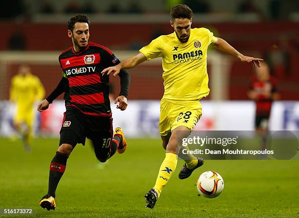 Alfonso Pedraza of Villarreal and Hakan Calhanoglu of Bayer Leverkusen battle for the ball during the UEFA Europa League round of 16, second leg...