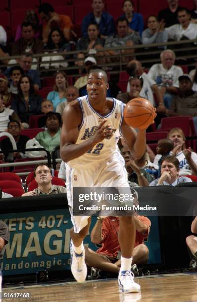 Dwight Howard of the Orlando Magic looks to make a play upcourt against the Dallas Mavericks during a preseason game at TD Waterhouse Centre on...