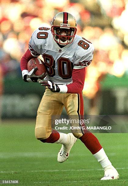San Francisco 49ers All-Pro wide-receiver Jerry Rice runs down field after catching a pass from 49ers quarterback Steve Young during an exhibition...