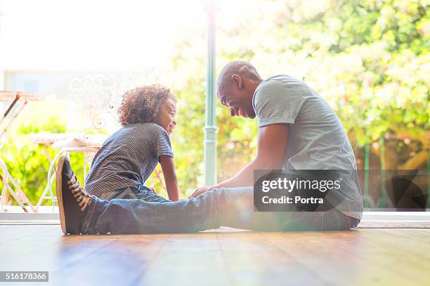 happy father and daughter sitting on floor at home - kid sitting stock pictures, royalty-free photos & images