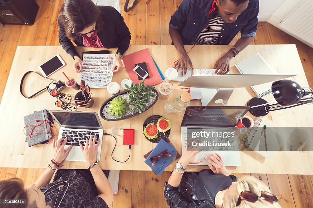 High angle view of creative people working at the table