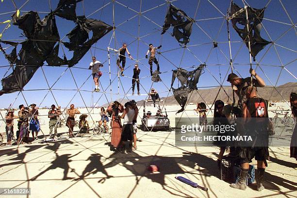Group of people prepare the fighters under the "Thunderdome" for a performance inspired in Mel Gibson's saga "Mad Max" at Black Rock City's Burning...