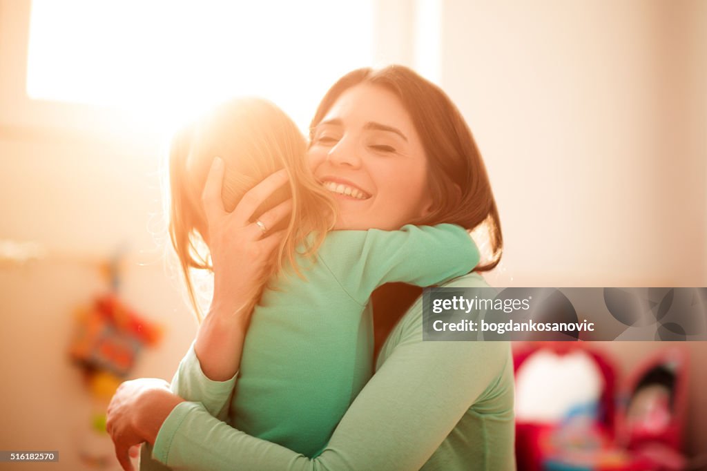 Mother and daughter hugging