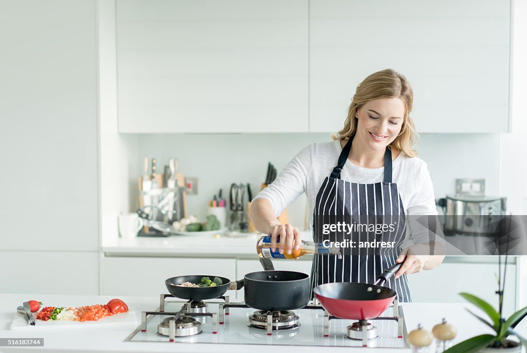 Happy woman cooking at home