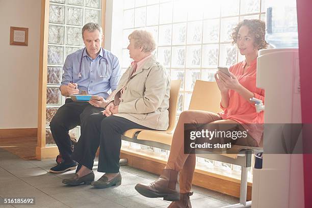 checking her details are up to date - doctor stethoscope patient whole body stock pictures, royalty-free photos & images