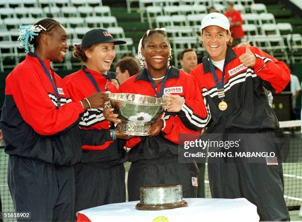 Lindsay Davenport gives a thumbs up as teammates, Venus Williams, Monica Seles, and Serena Williams of the USA pose after receiving the Fed Cup...