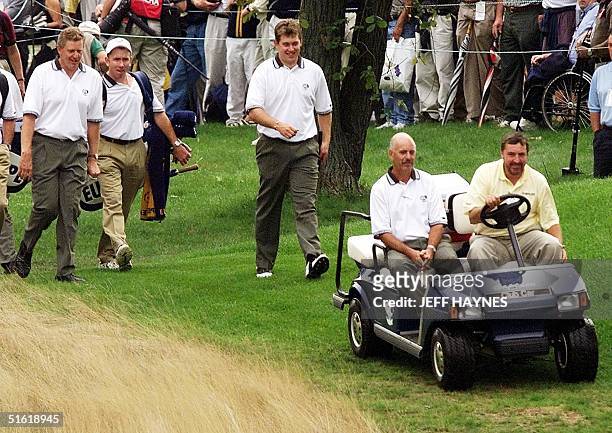 European Ryder Cup team members Colin Montgomrie of Scotland and Lee Westwood of England walk behind team captain Mark James during their practice...