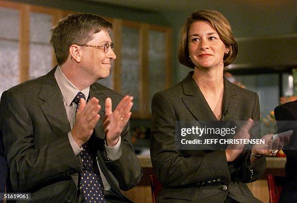 Microsoft Chairman and CEO Bill Gates looks at his wife Melinda 16 September 1999 during a press conference in Seattle where they announced the...