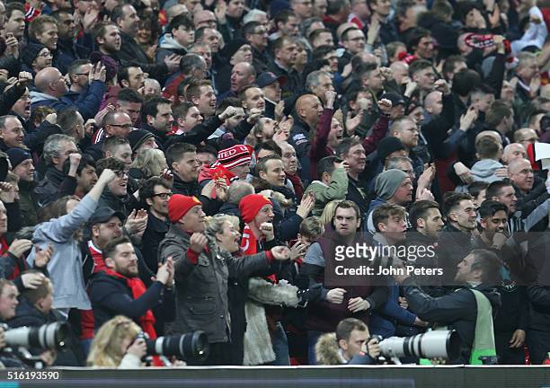 Manchester United fans celebrate Anthony Martial scoring their first goal during the UEFA Europa League Round of 16 Second Leg match between...