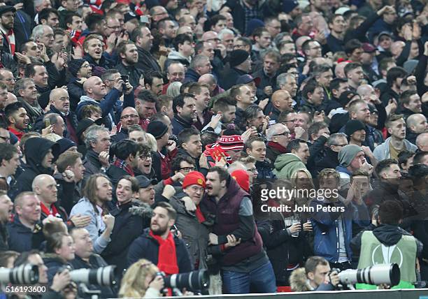 Manchester United fans celebrate Anthony Martial scoring their first goal during the UEFA Europa League Round of 16 Second Leg match between...