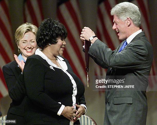 President Bill Clinton along with First Lady Hillary Rodham Clinton award singer Aretha Franklin with the 1999 National Medal of Arts and Humanities...