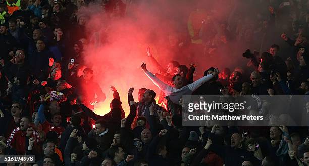 Liverpool fans celebrate Philippe Coutinho scoring their first goal during the UEFA Europa League Round of 16 Second Leg match between Manchester...