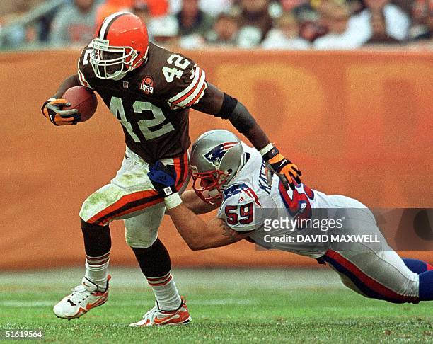 Cleveland Browns running back Terry Kirby is tackled by New England Patriots linebacker Andy Katzenmoyer after a short gain in the fourth quarter of...