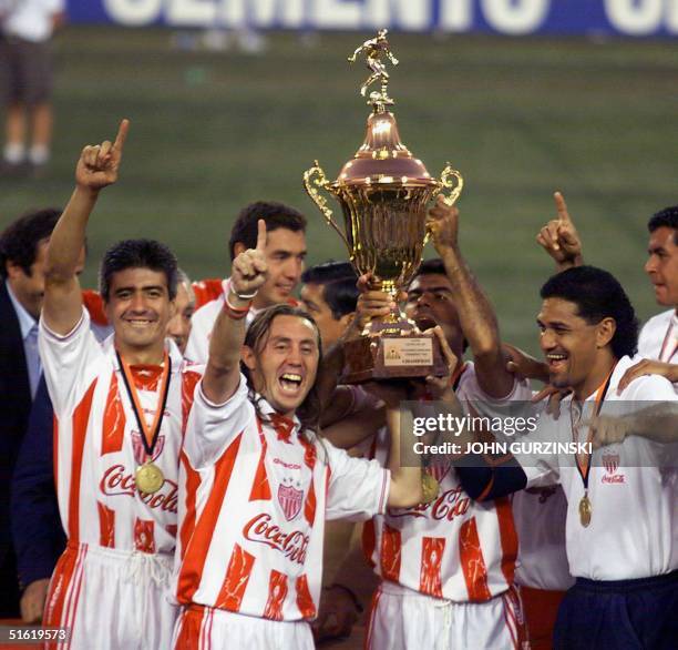 Players of Mexico's Necaxa hold their CONCACAF Champions Cup as they celebrate following their 2-1 win over Alajuela of Costa Rica 03 October 1999 in...