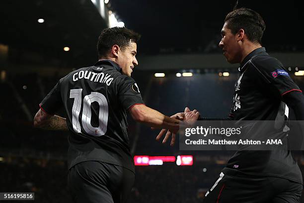 Philippe Coutinho of Liverpool celebrates scoring his team's first goal with team-mate Roberto Firmino during the UEFA Europa League Round of 16...