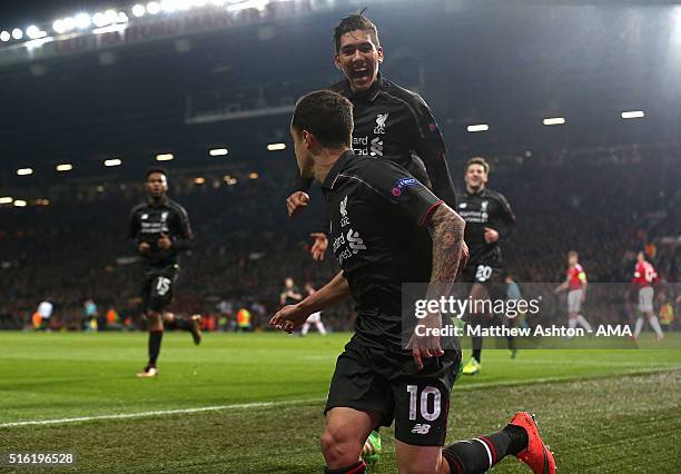 Philippe Coutinho of Liverpool celebrates scoring his team's first goal with team-mate Roberto Firmino during the UEFA Europa League Round of 16...