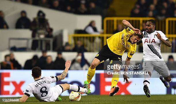 Tottenham Hotspur's English midfielder Ryan Mason vies with Borussia Dortmund's German defender Erik Durm during the UEFA Europa League round of 16,...