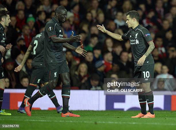 Liverpool's Brazilian midfielder Philippe Coutinho celebrates with Liverpool's French defender Mamadou Sakho after scoring their first goal during...