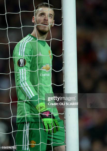 Manchester United's Spanish goalkeeper David de Gea reacts after conceding their first goal during the UEFA Europa League round of 16, second leg...