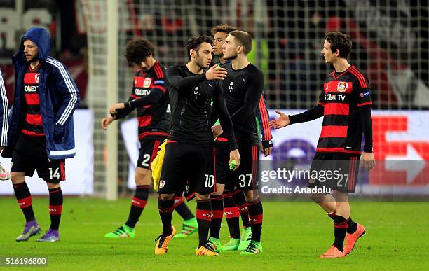 Football players of Bayer Leverkusen react at the end of the UEFA Europa League round of 16 second leg soccer match between Bayer Leverkusen and...