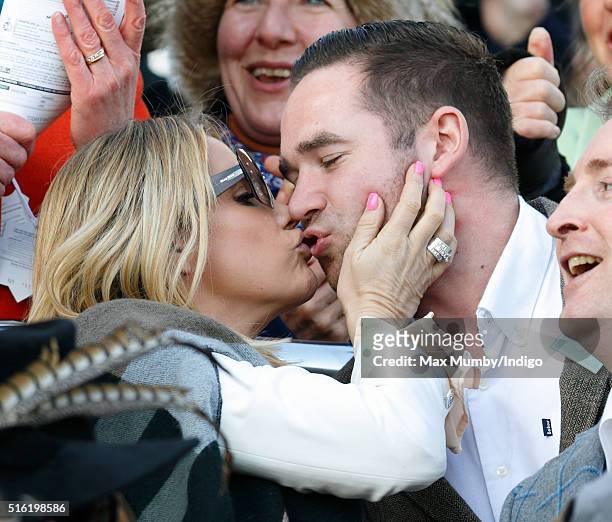 Katie Price kisses husband Kieran Hayler as they watch the racing on day 3, St Patrick's Day, of the Cheltenham Festival on March 17, 2016 in...