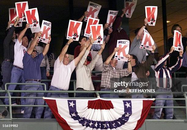 Boston Red Sox fans hold up posters bearing K's, symbolizing a strike out, for starting pitcher Pedro Martinez who finished the game with a total of...