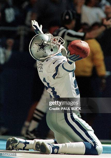 Deion Sanders of the Dallas Cowboys rejoices in the end zone after returning a punt for a touchdown in the fourth quarter against the Washington...