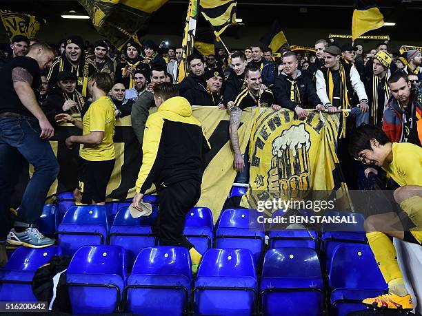 Borussia Dortmund's players celebrate with their supporters in the stands after the UEFA Europa League round of 16, second leg football match between...