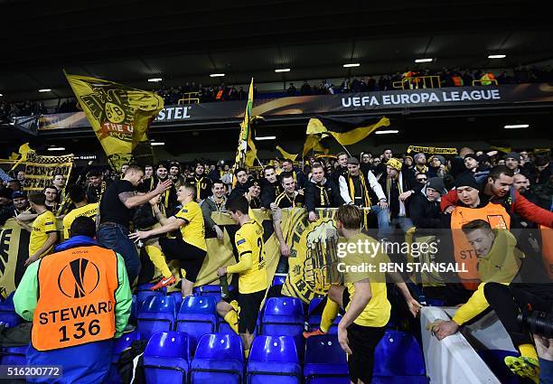 Borussia Dortmund's players celebrate with their supporters in the stands after the UEFA Europa League round of 16, second leg football match between...