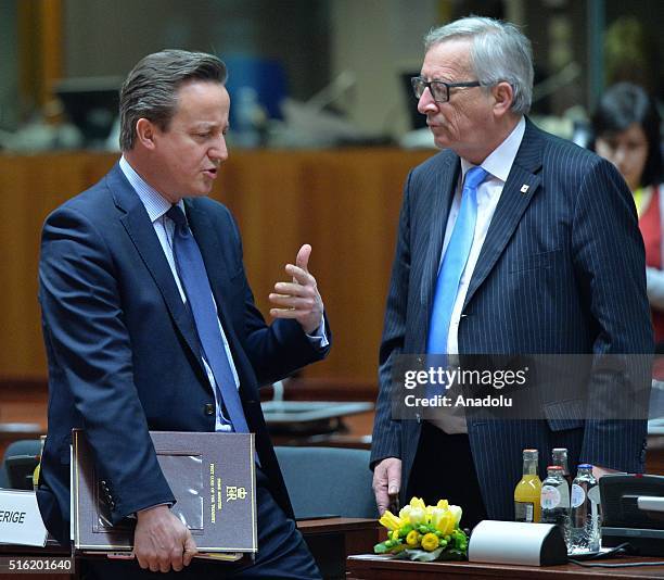 British Prime Minister David Cameron and President of the European Commission Jean-CLaude Juncker talk together on the first day of two days long...