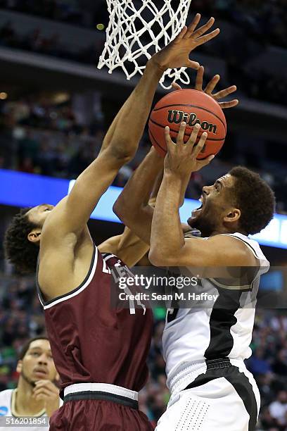 Thompson of the Purdue Boilermakers shoots the ball over Mareik Isom of the Arkansas Little Rock Trojans during the first round of the 2016 NCAA...