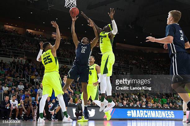 Justin Sears of the Yale Bulldogs puts up a shot against Al Freeman and Johnathan Motley of the Baylor Bears during the first round of the 2016 NCAA...