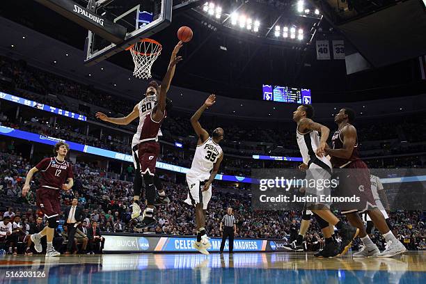 Hammons of the Purdue Boilermakers blocks a shot by Josh Hagins of the Arkansas Little Rock Trojans during the first round of the 2016 NCAA Men's...