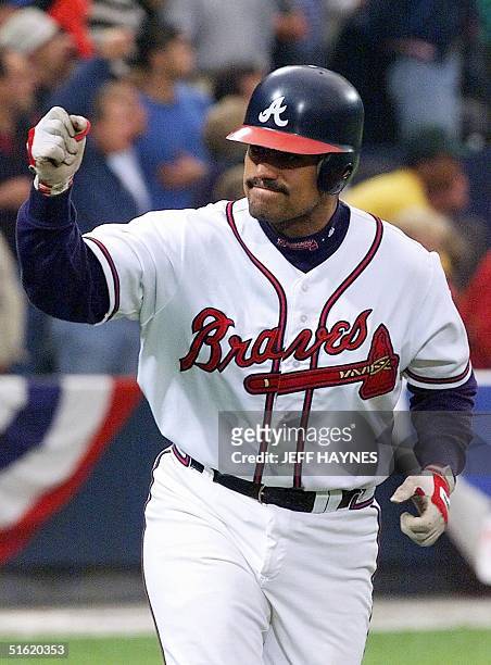 Catcher Eddie Perez of the Atlanta Braves pumps his fist after connecting on a two-run home run against the New York Mets 13 October during game two...