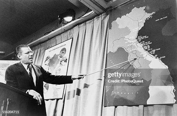 American politician US Secretary of Defense Robert McNamara points to a map of Vietnam during a press conference, Washington DC, April 26, 1965.