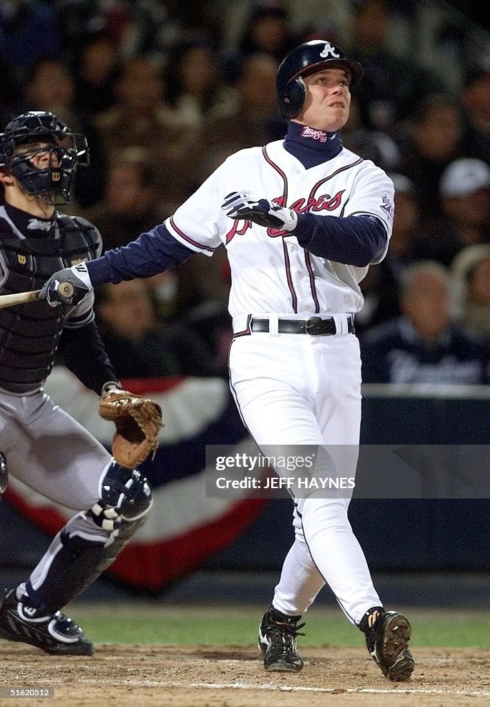 Chipper Jones (R) of the Atlanta Braves watches hi