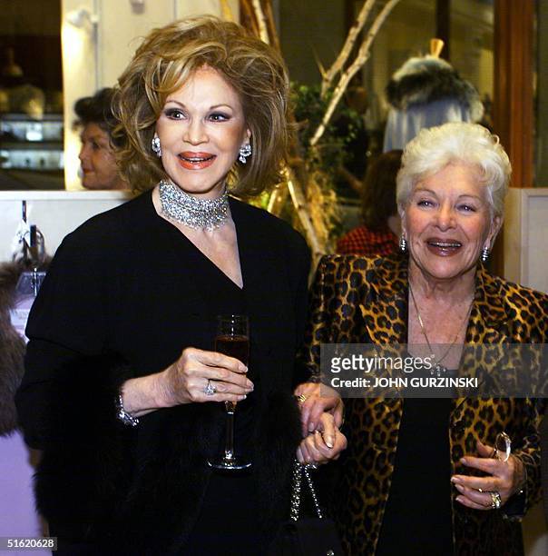 French singing legend Line Renaud appears with Phyllis McGuire, of the singing group "The McGuire Sisters," during the presentation of Renaud's new...