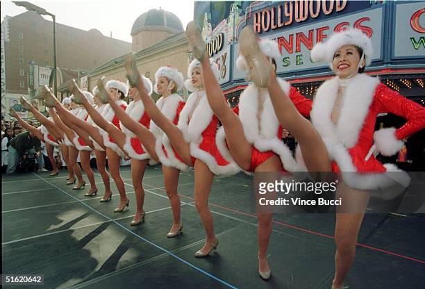 Members of the Radio City Rockettes perform their trademark high kicks outside the Guinness World of Records Museum on Hollywood Boulevard 27 October...