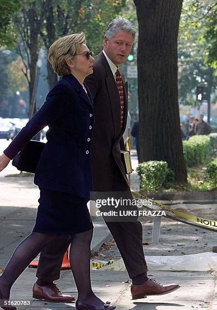 President Bill Clinton and First Lady Hillary Clinton walk into the Foundry United Methodist Church in Washington 31 October 1999 to attend Sunday...